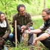 Julia und Johannes Bachmeir inspizieren mit Förster Friedrich Wendorff (rechts) die im Frühjahr gepflanzten Bäume in einem Wald bei Penzing.