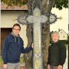 Rund 150 Jahre alt ist dieses gusseiserne Wegkreuz unweit des Bahnhofes in Pfaffenhausen, das Martin (links) und Herbert Schröder nun nach Vorgaben eines Kunstprofessors und mithilfe mehrerer Unterstützer renoviert haben. Die Rückseite des Kreuzes ist bis auf zwei kleine Symbole deckungsgleich mit der – nun teils vergoldeten – Vorderseite, was sehr ungewöhnlich ist. 	