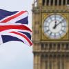Eine Britische Fahne weht vor dem berühmten Uhrenturm Big Ben in London.
