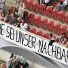 Deutsche Fußballfans habenan der Bande ein Transparent "Jerome Boateng sei unser Nachbar" angebracht beim Länderspiel Deutschland - Slowakei in der WWK-Arena in Augsburg.