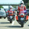 Zwei Motorräder des Bayerischen Roten Kreuzes (BRK) fahren bei Augsburg  durch die Rettungsgasse eines Staus. 