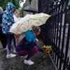Eine Frau legt Blumen nieder vor den Toren des Palace of Holyroodhouse nach der Bekanntgabe des Todes von Königin Elizabeth II.