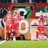 Torschütze Mergim Berisha (l-r), Dion Beljo und Jeffrey Gouweleeuw vom FC Augsburg jubeln über den Treffer zum 1:0 gegen Bayer Leverkusen.