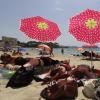 Eine Familie genießt die Sonne und den Strand auf Mallorca - doch nun gibt es wieder eine Reisewarnung für fast ganz Spanien.