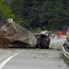 A car lies under a giant rock on the A2 Gotthard freeway near Gurtnellen, Canton of Uri on Wednesday, May 31 2006. Two people were killed in the rockslide when several big rocks of about 20 cubic meters came down at around 6:30 a.m. EPA/SIGI TISCHLER +++(c) dpa - Bildfunk+++