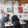 Die Friedberger Kunstspechte helfen zusammen beim Aufbau ihrer Ausstellung im Café Divano. Die Bilder können dort erworben werden und der Ertrag wird gespendet.