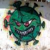 Ein Graffiti zum Coronavirus ist in Gaza an einer Wand zu sehen, an die sonst politische Botschaften und Aufrufe gesprüht werden.