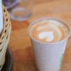 Ein Cappuccino mit Herzform im Milchschaum, den ein Mitarbeiter eines Cafés in Berlin-Mitte zubereitet hat, steht auf einem Tisch.