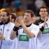 Die deutschen Spieler umd Silvio Heinevetter (links), Martin Strobel  (Mitte)und Erik Schmidt wollen bei der Handball-WM 2015 mindestens ins Achtelfinale einziehen.