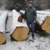 Holzvertriebsleiter Georg Dischner und sein Hund Anton stehen am teuersten Stamm des Forstbetriebs Kaisheim bei der diesjährigen Submission in Bopfingen. 	