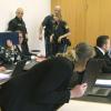 Drei der vier Angeklagten der "Firmenwelten"-Gruppe zum Prozessauftakt in Augsburg mit ihren Anwälten. 