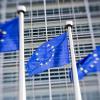Europäische Flaggen (mit einem Spezialobjekt verfremdet) wehen vor dem Gebäude der EU-Kommission in Brüssel. Hier stellt Kommissionspräsident Jean-Claude Juncker heute seine Reformpläne vor, die eine Revolution bedeuten würden, wenn sie tatsächlich umgesetzt werden. 