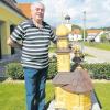 Stolz zeigt Johann Schuster seine Holzkirche. Er hat die Kirche St. Leonhard im Hintergrund nachgebaut.  