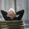 Senioren sitzen auf einer Bank in Berlin und genießen die Sonne.