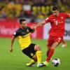 Dortmunds Raphael Guerreiro (l) und Bayerns Robert Lewandowski kämpfen um den Ball.
