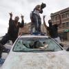 epa04723508 Youths stand on a demolished police car as police respond to people protesting the death of Freddie Gray, in Baltimore, Maryland, USA, 27 April 2015. Freddie Gray died on 19 April from a spinal injury sustained while in police custody. Gray's death has sparked protests that led to clashes with police and arrests of dozens of people over the weekend. EPA/MICHAEL REYNOLDS +++(c) dpa - Bildfunk+++