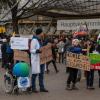 Die kranke Erde im Rollstuhl: Klima-Aktivisten demonstrieren vor der Olympiahalle in München, wo die Siemens-Hauptversammlung stattfindet. 