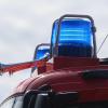 Blaulichter leuchten auf dem Dach eines Einsatzfahrzeugs der Feuerwehr.