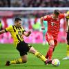 Raphael Guerreiro (l.) und Borussia Dortmund wollen Joshua Kimmich und dem FC Bayern im Meisterrennen ein Bein stellen.