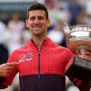 Novak Djokovic zeigt auf die 23 auf seiner Trainingsjacke und jubelt über seinen Sieg.