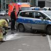 Ein Polizist und Feuerwehrmänner am Unfallort in Berlin.