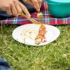 Schnell landet beim Grillen ein Stück Wurst oder Ketchup auf der Picknickdecke - die Flecken sollte man mit kaltem Wasser behandeln.