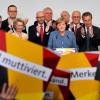 German Chancellor and Christian Democrats party CDU leader Angela Merkel C speaks on stage surrounded by her team during the election night event at the CDU partys headquarters in Berlin during the general election on September 24, 2017. 
Germany voted in a general election expected to hand Chancellor Angela Merkel a fourth term, while the hard-right Alternative for Germany AfD party is predicted to win its first seats in the national parliament.  / AFP PHOTO / Tobias SCHWARZ