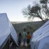 Kinder stehen zwischen Zelten in einem provisorischen Flüchtlingslager auf Lesbos.