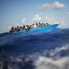 Migranten sitzen in einem Holzboot südlich der italienischen Insel Lampedusa auf dem Mittelmeer. Für die EU wird illegale Migration zur Bewährungsprobe.