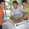 Florian, Raphael und Simon (von links) wollen wissen, wie schnell das Wasser im Boden versickert. 	