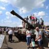 Besucher des Tages der Bundeswehr lassen sich auf dem Fliegerhorst auf einem Panzer fotografieren.