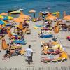Touristen genießen die Sonne an einem Strand auf der griechischen Insel Kos. Die Hoffnung auf Grenzöffnungen für den Sommerurlaub wächst von Tag zu Tag.