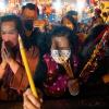Gläubige mit Mund-Nasen-Schutz verbrennen ihre ersten Räucherstäbchen, während sie im Wong-Tai-Sin-Tempel in Hongkong das Neujahrsfest feiern.