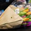 Schnittblumen liegen in einem Supermarkt an der Kasse auf dem Band.