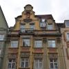 Dieses Haus in der Karolinenstraße 15 in Augsburg mischt Elemente aus dem Barock, wie die Zopfgirlanden über den Fenstern, und aus dem Klassizismus, wie die drei Säulen.