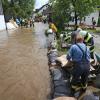 Helfer arbeiten in dem vom Tiefenbach überfluteten Polling.