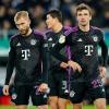 Die Bayern-Profis Konrad Laimer, Min-jae Kim und Thomas Müller (l-r) wirken nach dem Spiel fassungslos.