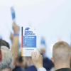 Delegierte halten bei einer Abstimmung Stimmkarten bei dem AfD-Bundesparteitag in der Magdeburger Messe hoch. Auch Äußerungen von Friedrich Merz waren Thema.