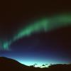 Polarlicht erhellt den Nachthimmel über der Arktis. Das einzigartige Naturschauspiel ist die Folge von Sonnenstürmen, die das Magnetfeld der Erde Verformen.