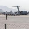 Familien werden für deren Evakuierung zu einer Boeing C-17 auf dem Flughafen Kabul geleitet.