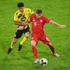 Dortmunds Mahmoud Dahoud (l) versucht Bayerns Joshua Kimmich den Ball abzunehmen.