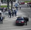 Leibwächter bringen den slowakischen Ministerpräsidenten Robert Fico in einem Auto in Sicherheit. Fico war nach einer Kabinettssitzung in der Stadt Handlova angeschossen und verletzt worden. 