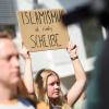 Eine Demonstrantin hält auf einer Gegenkundgebung ein Schild mit der Aufschrift "Islamismus ist richtig Scheiße" in die Höhe.