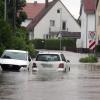 Autos stehen im Hochwasser der Mindel in einem Wohngebiet.