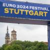 Die Türme der Stiftskirche ist beim Aufbau des Public Viewing für die Fußball-Europameisterschaft in Deutschland auf dem Stuttgarter Schlossplatz hinter einem Eingang zur Fanmeile zu sehen.