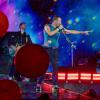 Chris Martin, Sänger der britischen Band Coldplay, Ende Juli 2024 bei strömendem Regen in Düsseldorf auf der Bühne. 