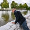 Wie schlimm wird das Hochwasser? Frank Balzer (SPD), der Bürgermeister von Eisenhüttenstadt, blickt über einen Wall aus Sandsäcken im Stadtteil Fürstenberg, wo Straßen überflutet wurden.