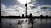 Und auch in nahegelegenen Düsseldorf bleibt die Hochwasserlage angespannt. Hinter Bäumen fährt ein Frachtschiff auf dem Rhein.
