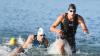 Die beiden Deutschen Jan Frodeno (r) und Patrick Lange (M) kommen 2018 bei der Ironman Europameisterschaft nach dem Schwimmen im Langener Waldsee aus dem Wasser.