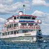 Ab Sonntag, 10. April 2022, sind die Schiffe der Vereinigten Schifffahrtsunternehmen für den Bodensee und Rhein (VSU) wieder auf dem gesamten Bodensee unterwegs. Nachdem sich der Saisonstart in den letzten zwei Jahren aufgrund der Corona-Pandemie verzögert hatte, ist in diesem Jahr einer Pressemitteilung der VSU zufolge erstmals wieder ein pünktlicher Start möglich. "Wir freuen uns, nach einem langen Winter endlich wieder Leben auf den See zu bringen und gerade in diesen für alle schwierigen Zeiten ein Stück Lebensfreude bieten zu können", so VSU-Vorsitzender Frank Weber.
Corona war auch hier spürbarAlle Schifffahrtsunternehmen haben die Auswirkungen der Pandemie in den letzten beiden Jahren deutlich zu spüren bekommen: "Hinsichtlich der Fahrgastzahlen waren 2020 und 2021 nicht mit einem normalen Jahr vergleichbar. Aufgrund des verspäteten Saisonstarts gingen wichtige Fahrtage verloren, dazu kamen längere Phasen mit schlechtem Wetter. Dadurch konnten wir zusammen zwar 2.287.460 Passagiere und damit rund neun Prozent mehr Fahrgäste als im Vorjahr an Bord begrüßen, was jedoch deutlich unter den Fahrgastzahlen der Jahre vor der Pandemie liegt", so die Bilanz von Frank Weber. "Das hatte auf uns alle natürlich auch finanzielle Auswirkungen, die wir so gut es ging abgefedert haben. Aber nun blicken wir optimistisch in die Zukunft. Die Buchungszahlen der Beherbergungseinrichtungen sind gut, weshalb wir uns bereits heute sehr auf unsere Gäste freuen, möglichst bei einer Saison ohne große Einschränkungen und mit Kaiserwetter."Es gibt wieder eine FlottensternfahrtEin erster Höhepunkt der Saison ist die 49. Internationale Flottensternfahrt am Samstag, den 30. April. Ziel der Schiffe ist Lindau, wo sie eine Sternformation bilden – ein beeindruckendes Manöver, das nach einem zweimaligen coronabedingten Ausfall, nicht alle Tage zu sehen ist. Dabei wird die grenzübergreifende Freundschaft zwischen Deutschland, Österreich und der Schweiz zelebriert.Das steht diese Saison auf dem ProgrammVom 10. April bis in den Oktober hinein fahren die Schiffe im Kursverkehr nach festem Fahrplan: Von Schaffhausen bis Kreuzlingen, von Konstanz nach Überlingen, von Meersburg nach Lindau und von Romanshorn bis Bregenz lädt die Weiße Flotte dazu ein, den Bodensee und Rhein zu erkunden. In die neue Saison starten die VSU mit diesem Programm: Neben Angeboten wie den Fahrten zu den Bregenzer Festspielen, bei denen in diesem Jahr die Oper "Madame Butterfly" gespielt wird, steht 2022 noch mehr auf dem Programm: Beispielsweiße gibt es kulinarische Fahrten wie den Osterbrunch, den Enten-Schmaus oder das Bayerische Frühstück. Neu ist in der Saison 2022 auch das gemeinsam mit "Maestrani Chocolaneum" angebotene Schoki-Schiff, bei dem Kinder Schokistängel verzieren und Schokolade in ihren unterschiedlichen Formen kennenlernen können. Ab dem Sommer wird zudem das erste Elektroschiff der BSB auf dem Überlinger See zwischen der Insel Mainau, Unteruhldingen und Meersburg verkehren – es stellt den Auftakt des Vorhabens dar, die BSB-Flotte bis 2035 klimaneutral fahren zu lassen. Programm der österreichischen Vorarlberg LinesDie österreichischen Vorarlberg Lines (VLB) bieten in dieser Saison ebenfalls wieder ein Programm an: Bei einer dreitägigen Kreuzfahrt am Bodensee mit neuen Routen erleben die Gäste den Bodensee von einer neuen Seite. Auf dem Eventschiff MS "Sonnenkönigin" gibt es Premiumfahrten zu verschiedenen Anlässen wie etwa Sonnenkönigin meets Schlager, dem Sommernachtsball der Königin, oder dem Captain’s Brunch. Außerdem läuft das Grill-Schiff deluxe wieder aus und es gibt auf dem Bodensee ein Krimidinner mit dem Namen "Viva la Muerte – Es lebe der Tod!" sowie ein Dinner-Musical mit dem Titel "The Musical Sound of Female Power".Programm der schweizerischen Bodensee SchifffahrtBei der Schweizerische Bodensee Schifffahrt (SBS) stehen ebenfalls Themenfahrten an. Die Klassiker wie der wöchentliche Sonntagsbrunch auf dem MS "Säntis" oder der MS "St. Gallen", die Fahrten zum Kreuzlinger Seenachtfest und die Erlebnisrundfahrten Thurgau finden auch in diesem Jahr wieder statt. Nach dem Erfolg der letzten zwei Jahre wird das Strickschiff 2022 drei Mal durchgeführt. Auch die Musikfahrten sowie die Tanz-Schiffe stechen dieses Jahr wieder in See.

Die Schweizerische Schifffahrtsgesellschaft Untersee und Rhein (URh) ist ebenfalls mit mehreren neuen Formaten bereit für die Saison: Im September geht es auf eine Kreuzfahrt mit dem Schauspieler, Maler und Musiker Nagelritz (Dirk Langer). Ausgestattet mit Schifferklavier, Gitarre und jeder Menge Geschichten begleitet er eine Reise auf dem Rhein. Von Mai bis Oktober wird man an jeweils an einem Samstag das Wochenende auf dem "Wii-Schiff" mit einer Reise durch die Weinlandschaft beginnen können. Und das Schiff-Hotel MS "Konstanz" lädt dazu ein, auf dem Schiff zu übernachten.

Nach dem Ende der Kursschifffahrt im Oktober ist die Schifffahrts-Saison am Bodensee allerdings noch nicht vorbei: Im Winter bieten die Unternehmen Herbst-, Advents- und Silvester- Fahrten an.
